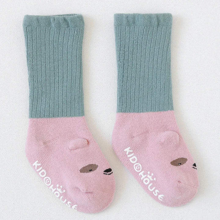 Pair of kids' socks with green ribbed cuffs and pink feet featuring cute bear faces and Kidohouse branding