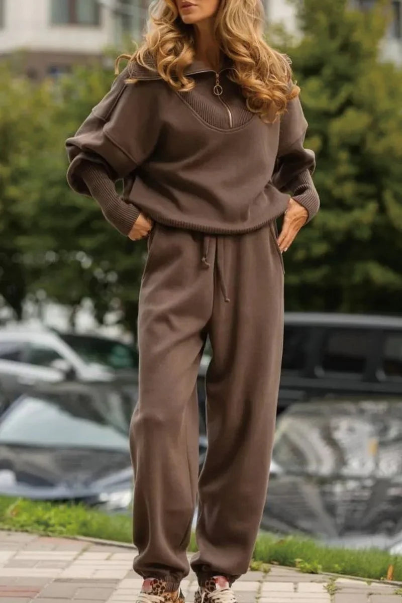Woman wearing a brown relaxed fit knit tracksuit with zip collar and drawstring pants outdoors