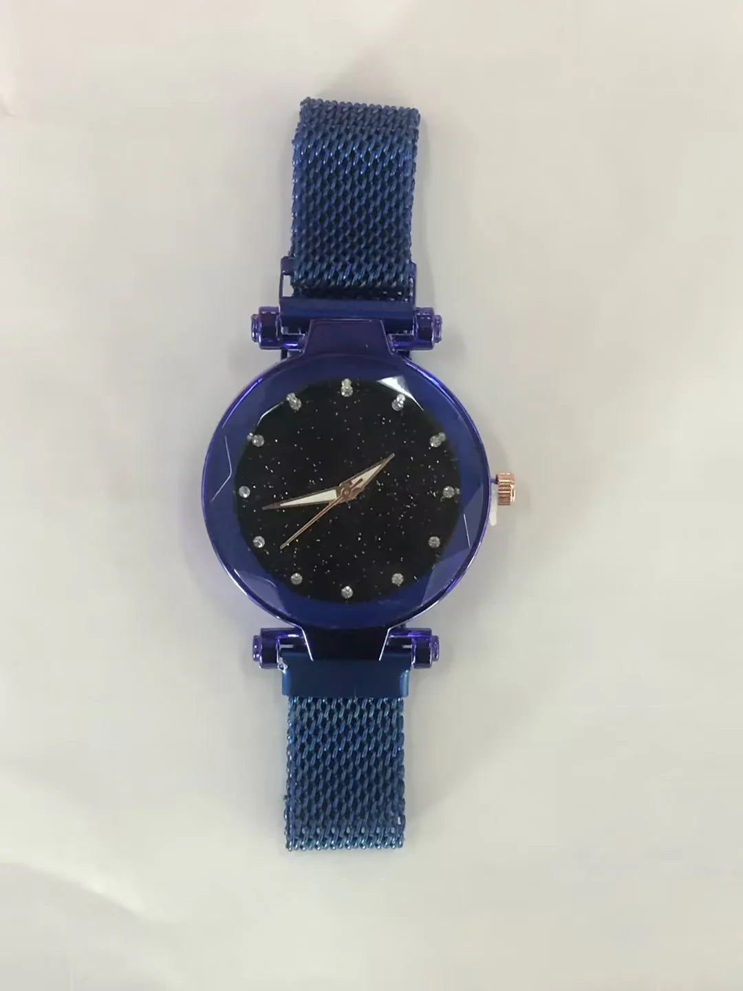 Blue wristwatch with a textured mesh band and a black starry dial with crystal hour markers