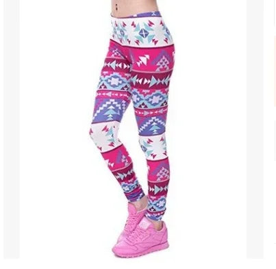 woman wearing colorful aztec print leggings paired with pink sneakers on white background