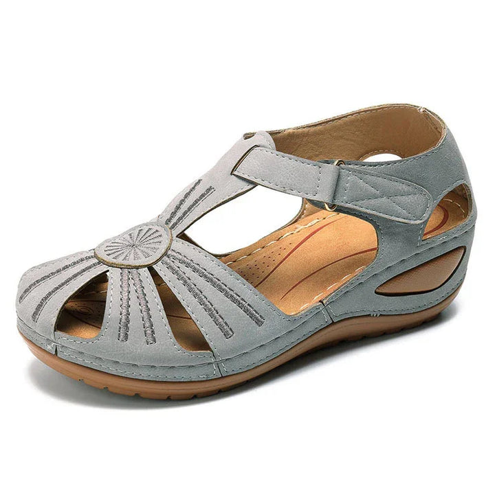 Light gray women’s open-toe casual sandal with slingback strap and cushioned brown sole