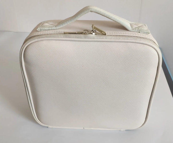 Cream-colored square cosmetic bag with zipper and handle on white surface
