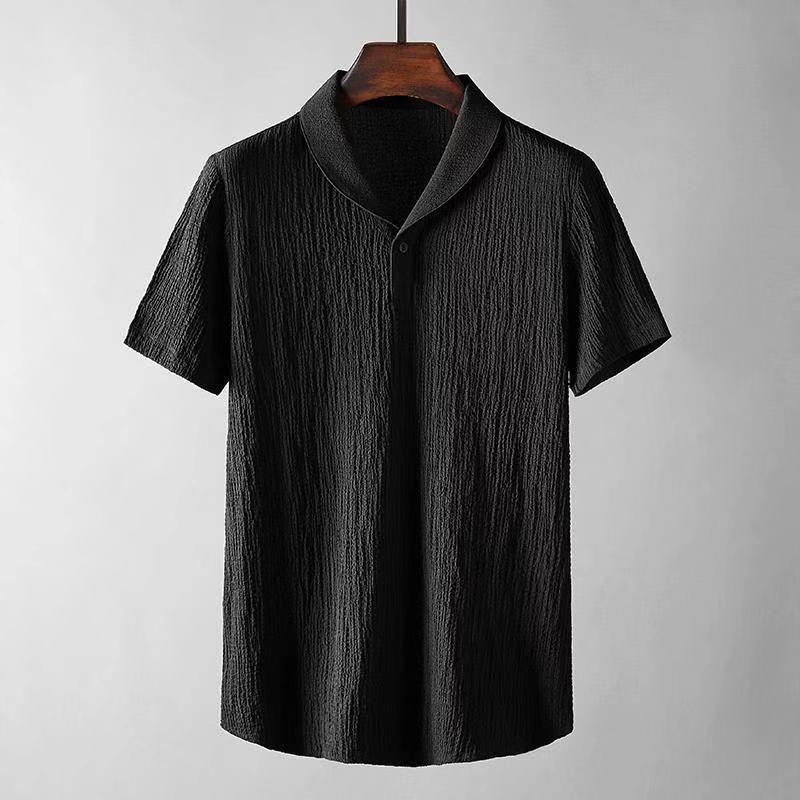 Black textured short-sleeve men's shirt with shawl collar hanging on wooden hanger