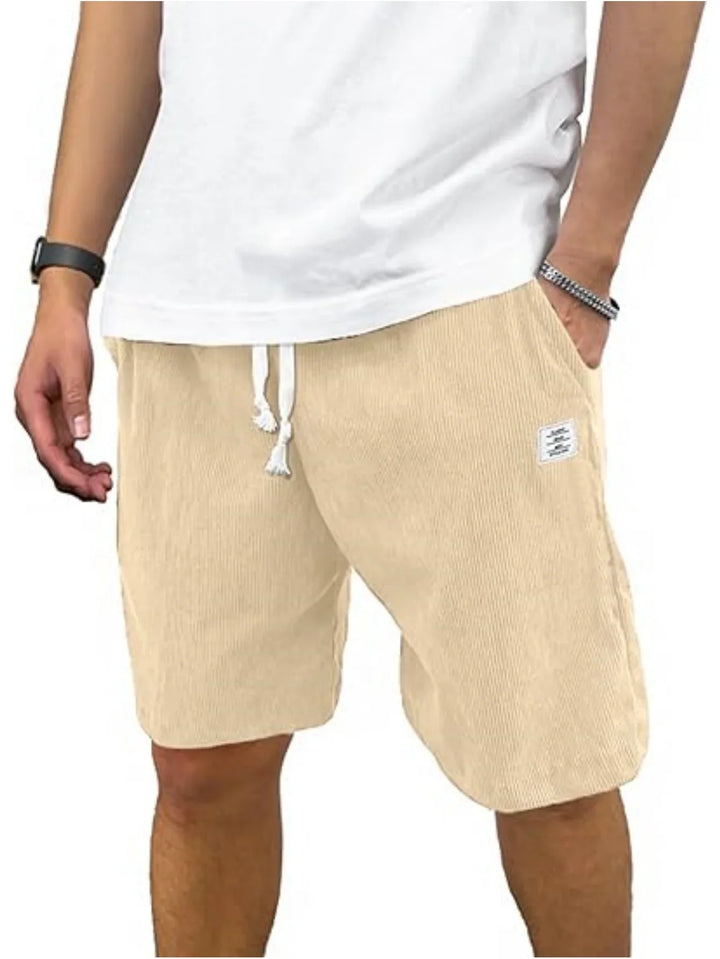 Man wearing beige corduroy shorts with drawstring and white t-shirt, casual summer outfit