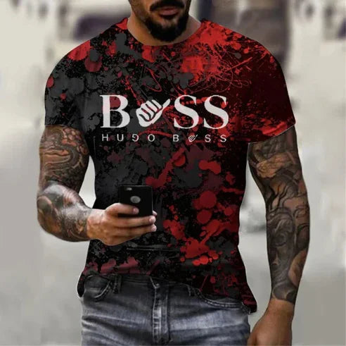 Man with tattooed arms wearing black and red Hugo Boss graphic t-shirt holding smartphone