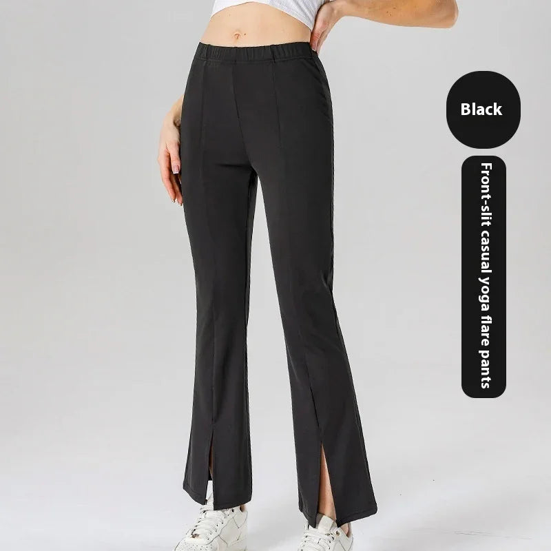 Black front-slit casual yoga flare pants worn with white sneakers and a cropped top