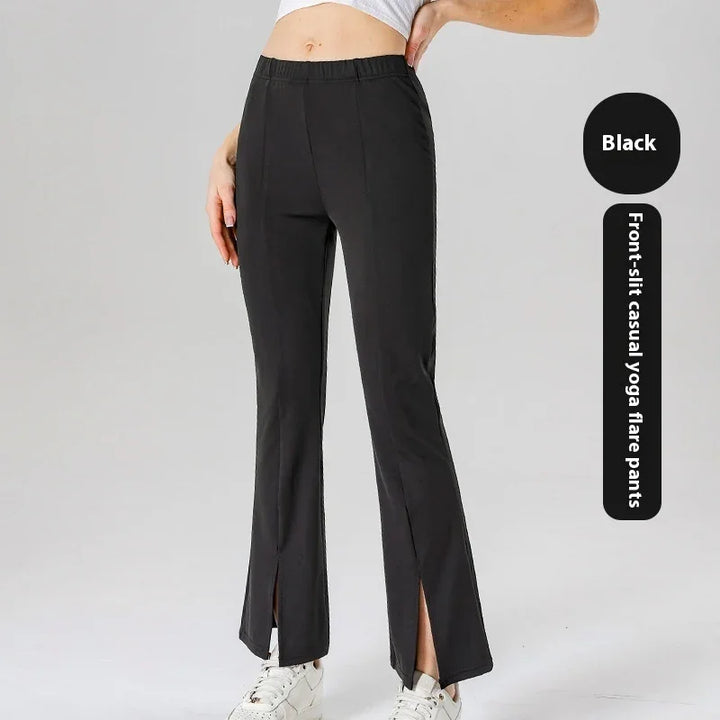 Black front-slit casual yoga flare pants worn with white sneakers and a cropped top