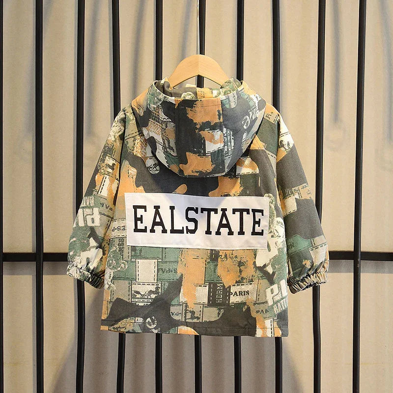 Kids hooded jacket with abstract camo print and EALSTATE text on back, hanging on wooden hanger