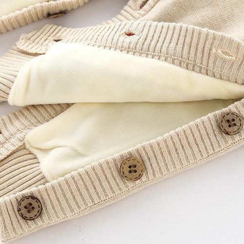 Beige knitted cardigan with wooden buttons and soft cream fleece lining, cozy winter sweater