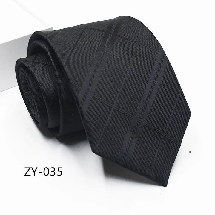 Black silk necktie with subtle diagonal check pattern, rolled and displayed on white background