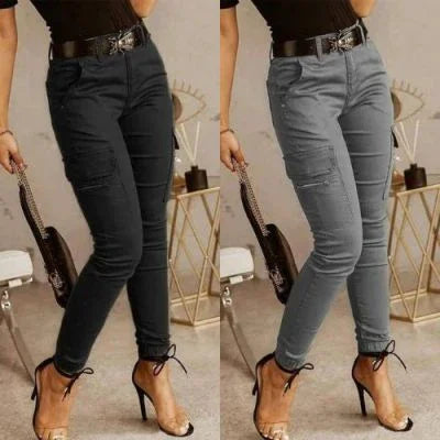 Side-by-side image of woman wearing black and gray high-waisted skinny jeans with distressed details and black belt, paired with black top and clear high heels