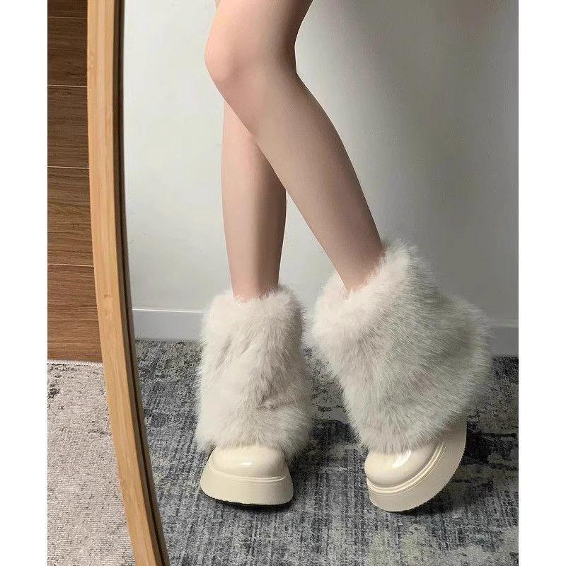legs wearing white fluffy fur boots on carpeted floor in front of full-length mirror