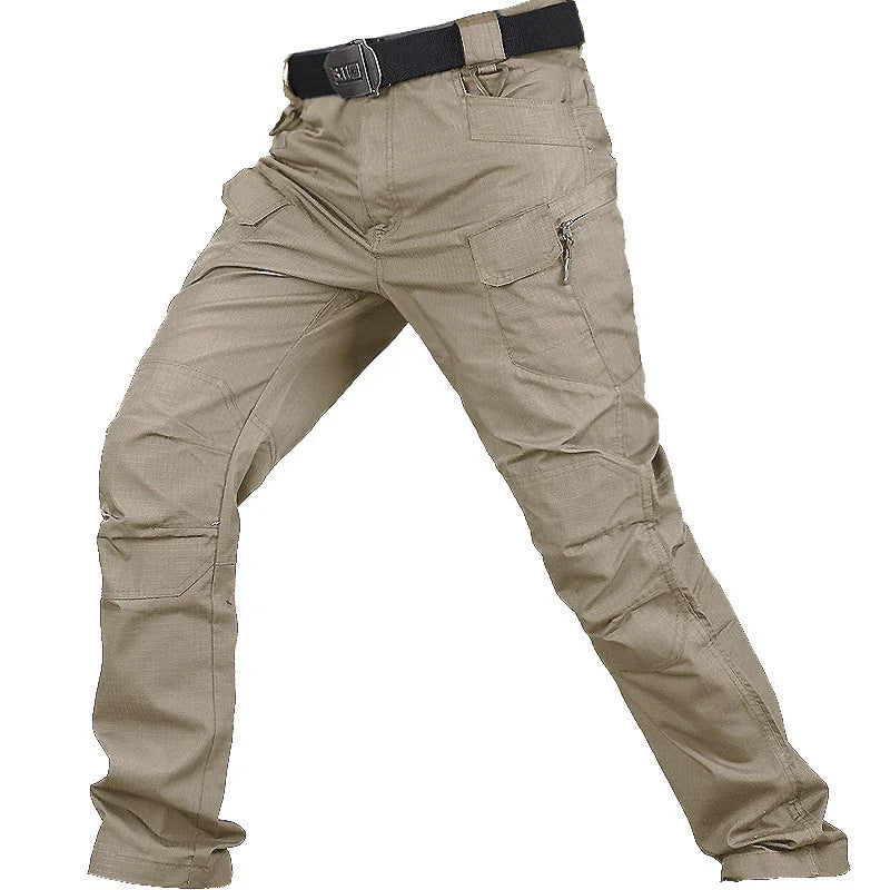 Men's beige tactical cargo pants with multiple pockets and a black belt on white background