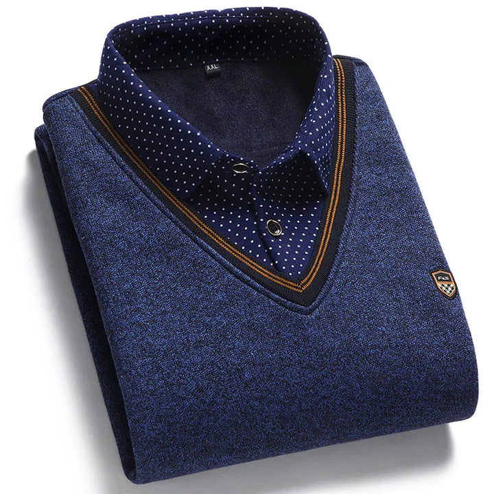 Folded blue men's sweater with V-neck and navy polka dot collared shirt layered underneath