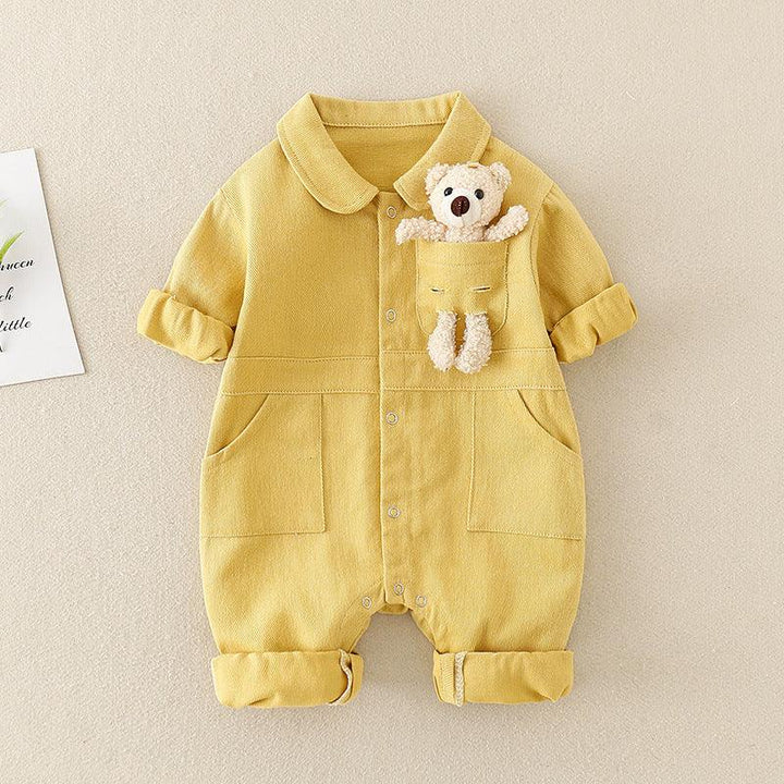 Yellow baby romper with rolled sleeves and pants, featuring a small teddy bear in the chest pocket