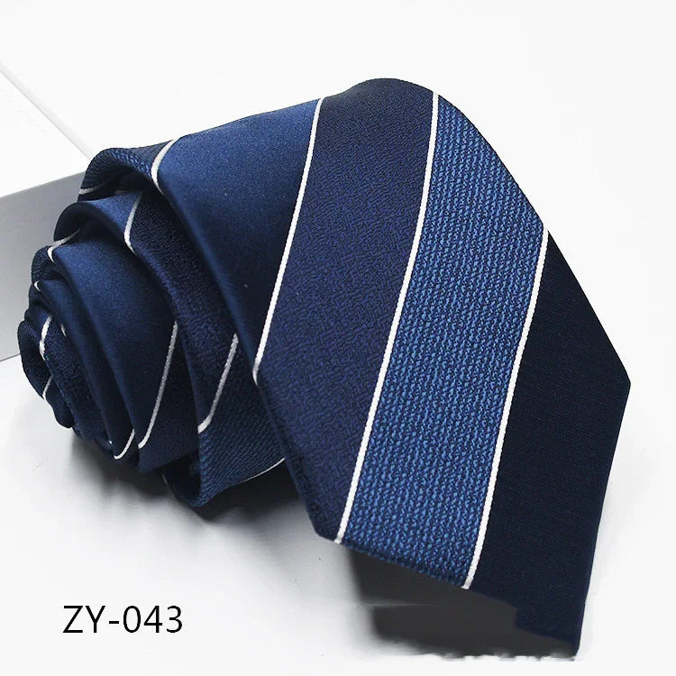 Stylish navy blue striped men's necktie with white lines, rolled up on white surface