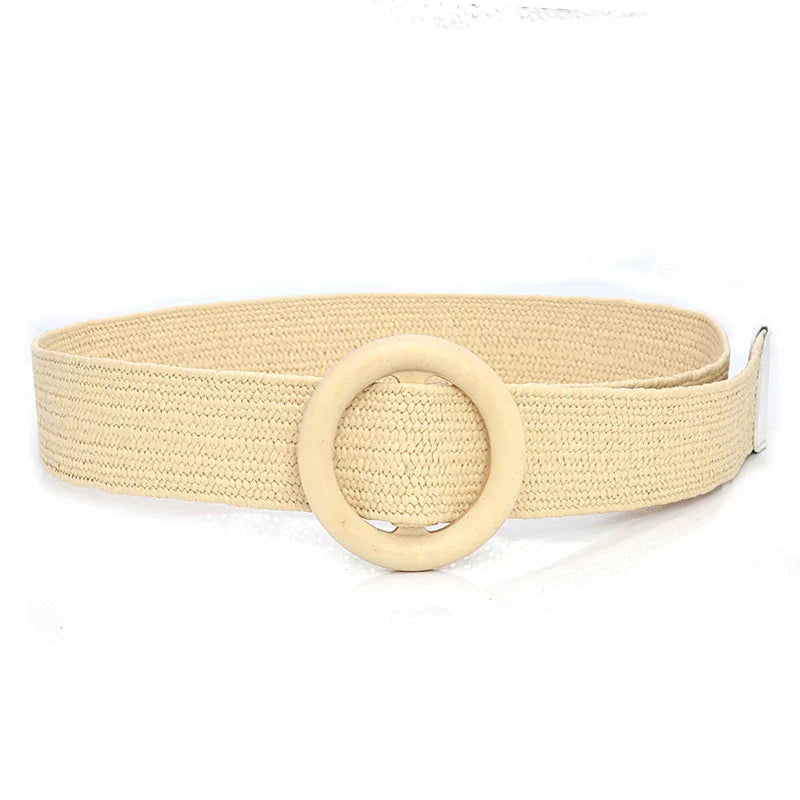 Beige woven belt with large round wooden buckle on white background