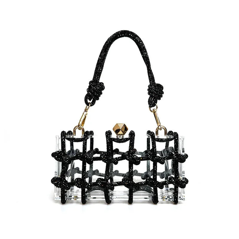 Clear acrylic handbag with black beaded knot design, gold hardware, and a short handle