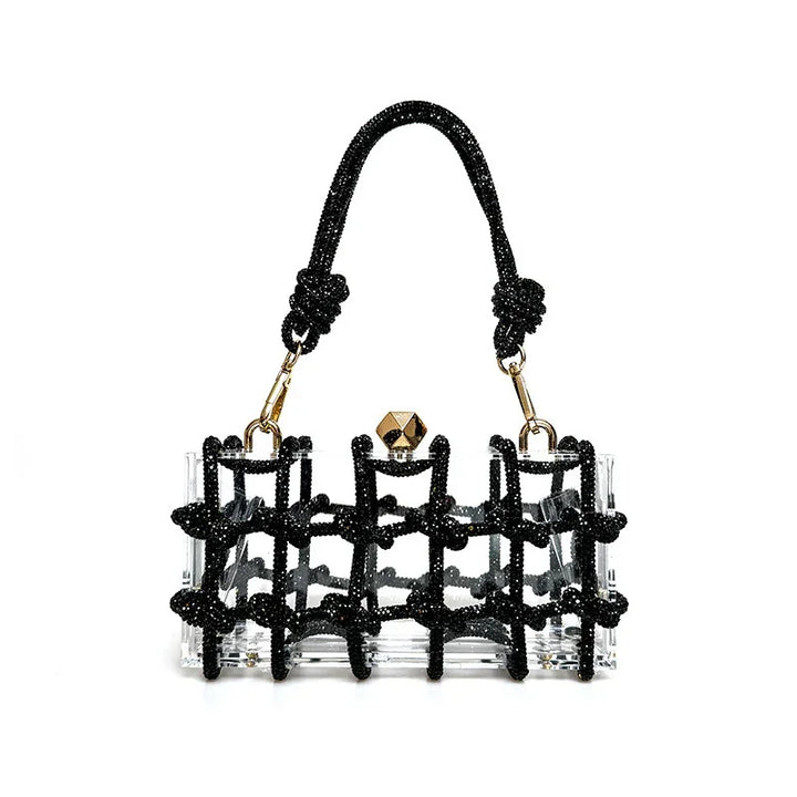 Clear acrylic handbag with black beaded knot design, gold hardware, and a short handle