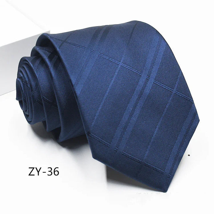 Rolled navy blue necktie with subtle diagonal stripes and checkered pattern on white background