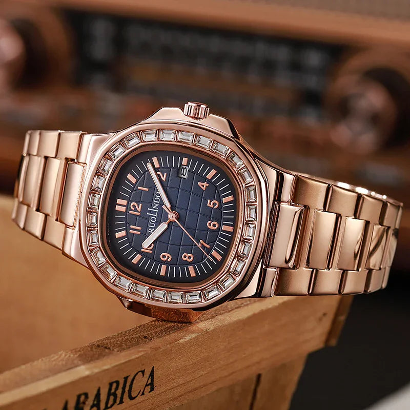 Rose gold RUOLINDO wristwatch with blue dial and crystal bezel on wooden surface