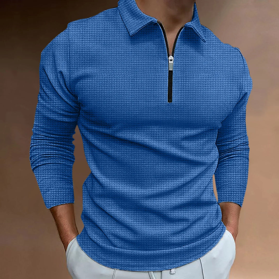 Man wearing blue textured long sleeve pullover with front zipper and collar