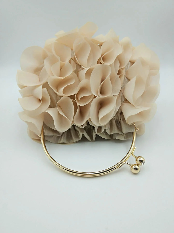 Beige floral fabric clutch bag with gold metal handle on white background