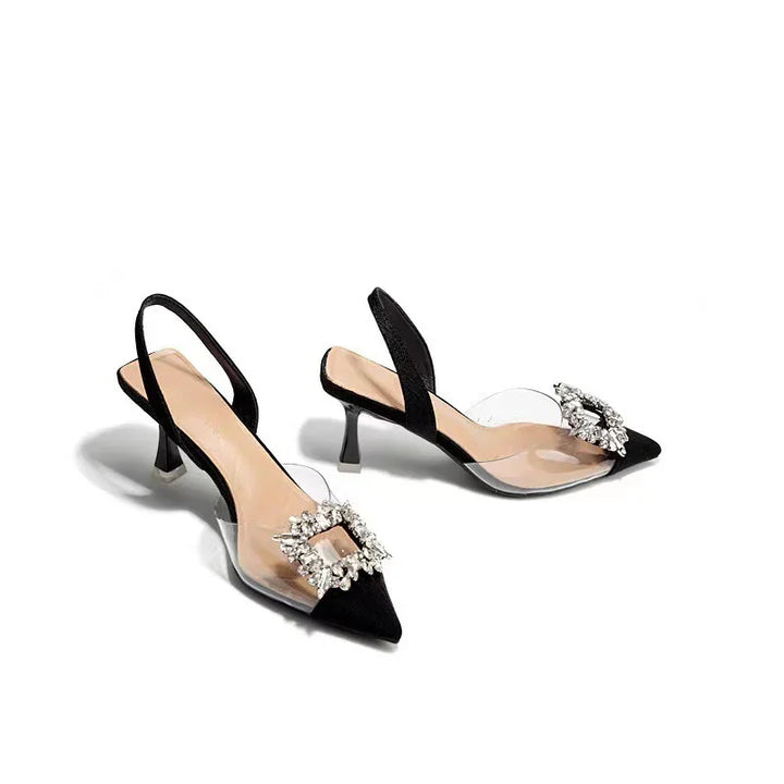 Elegant black slingback kitten heels with pointed toes and crystal buckle embellishments