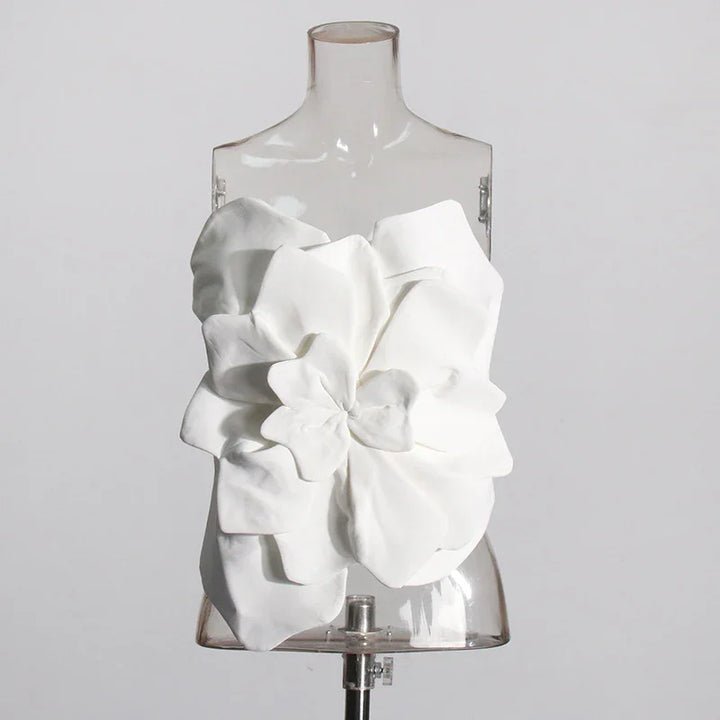 white strapless top with large layered fabric flower detail displayed on transparent mannequin
