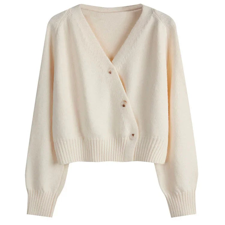 Cream-colored soft knit cardigan with V-neck and three buttons, ribbed cuffs and hem