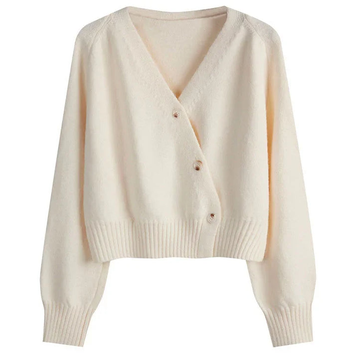 Cream-colored soft knit cardigan with V-neck and three buttons, ribbed cuffs and hem
