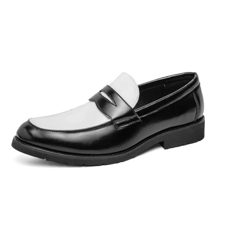 Black and white leather men's dress loafer with penny strap detailing on white background