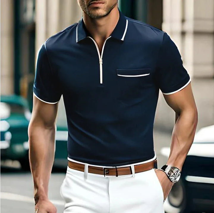 man wearing navy blue short sleeve polo shirt with white trim and white pants on city street