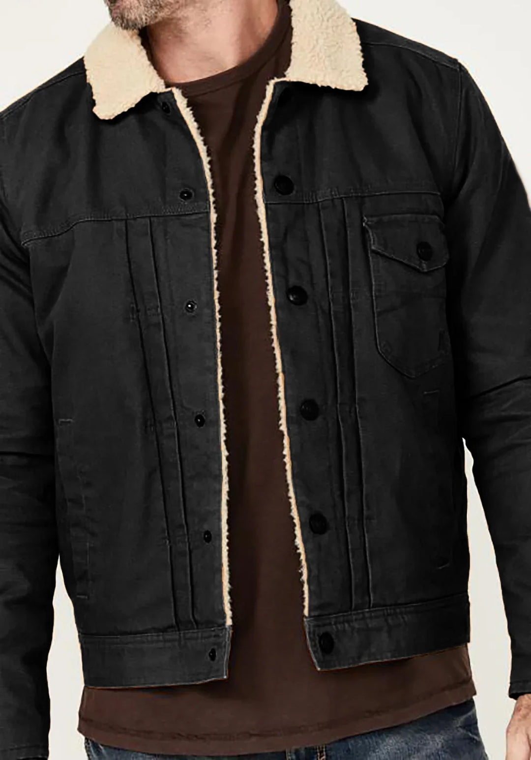 Men's black denim jacket with beige sherpa collar worn over brown shirt