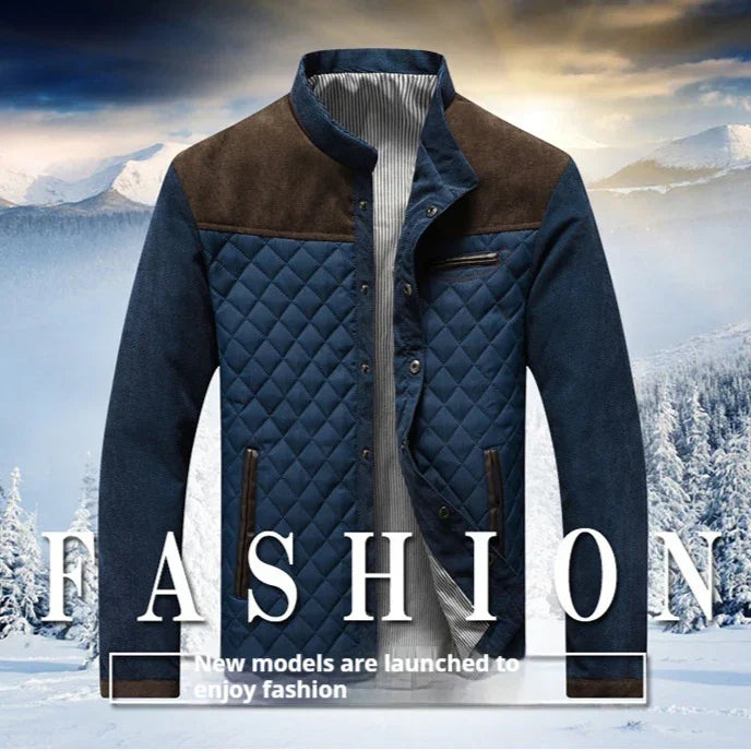 Men's quilted blue and brown jacket with stand collar displayed against snowy mountain background