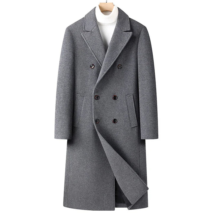 Men's gray double-breasted wool coat with notch lapels and side pockets over white turtleneck
