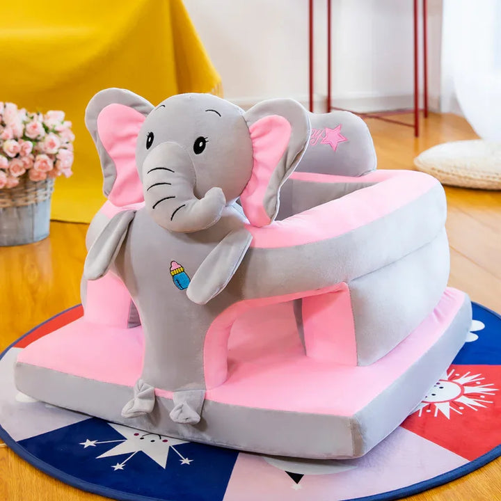 Gray and pink plush elephant baby walker on colorful round rug in bright room