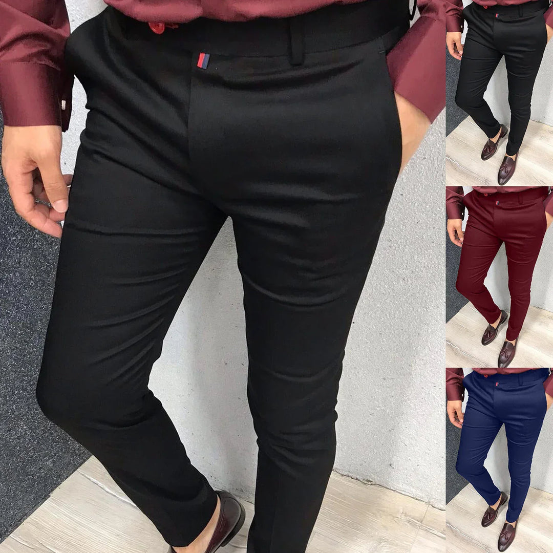 Men's slim fit dress pants in black, burgundy, and navy with maroon shirt and loafers on light floor