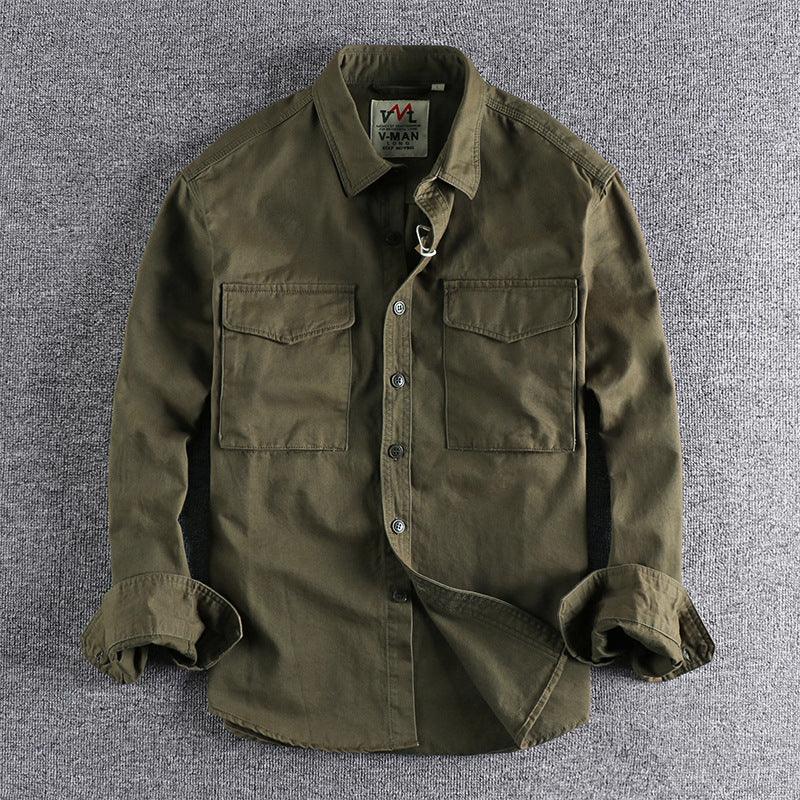 Men's olive green button-up shirt with two chest pockets and rolled-up sleeves on gray background