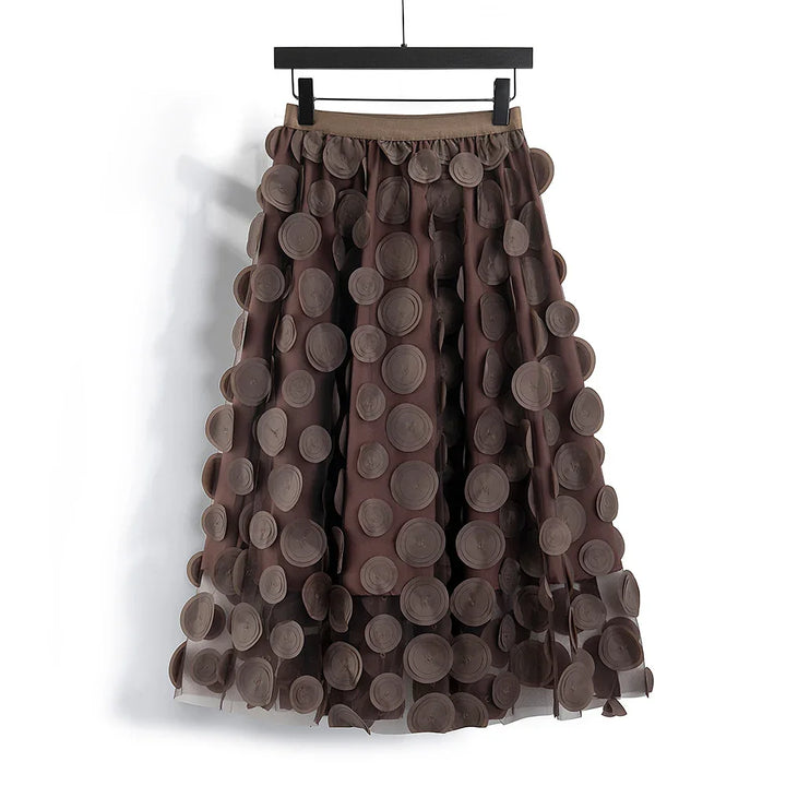 Brown midi skirt with 3D circular applique details hanging on black hanger
