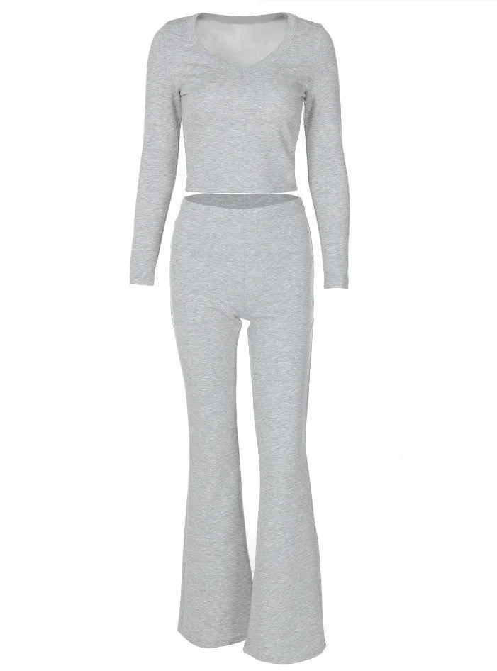 Gray long sleeve cropped top with high-waisted flared pants set on white background