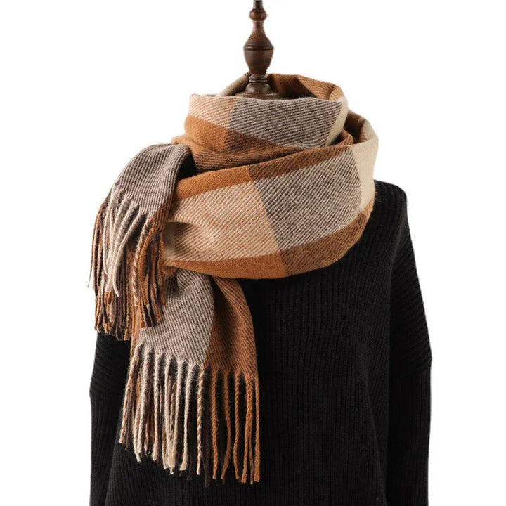 Brown and beige plaid wool scarf with fringes draped on black knit sweater mannequin