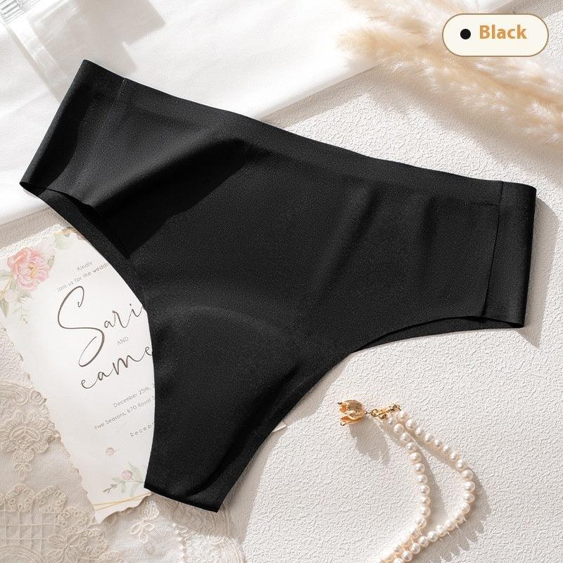 Black seamless high-waist women's underwear on white surface with lace and pearl bracelet