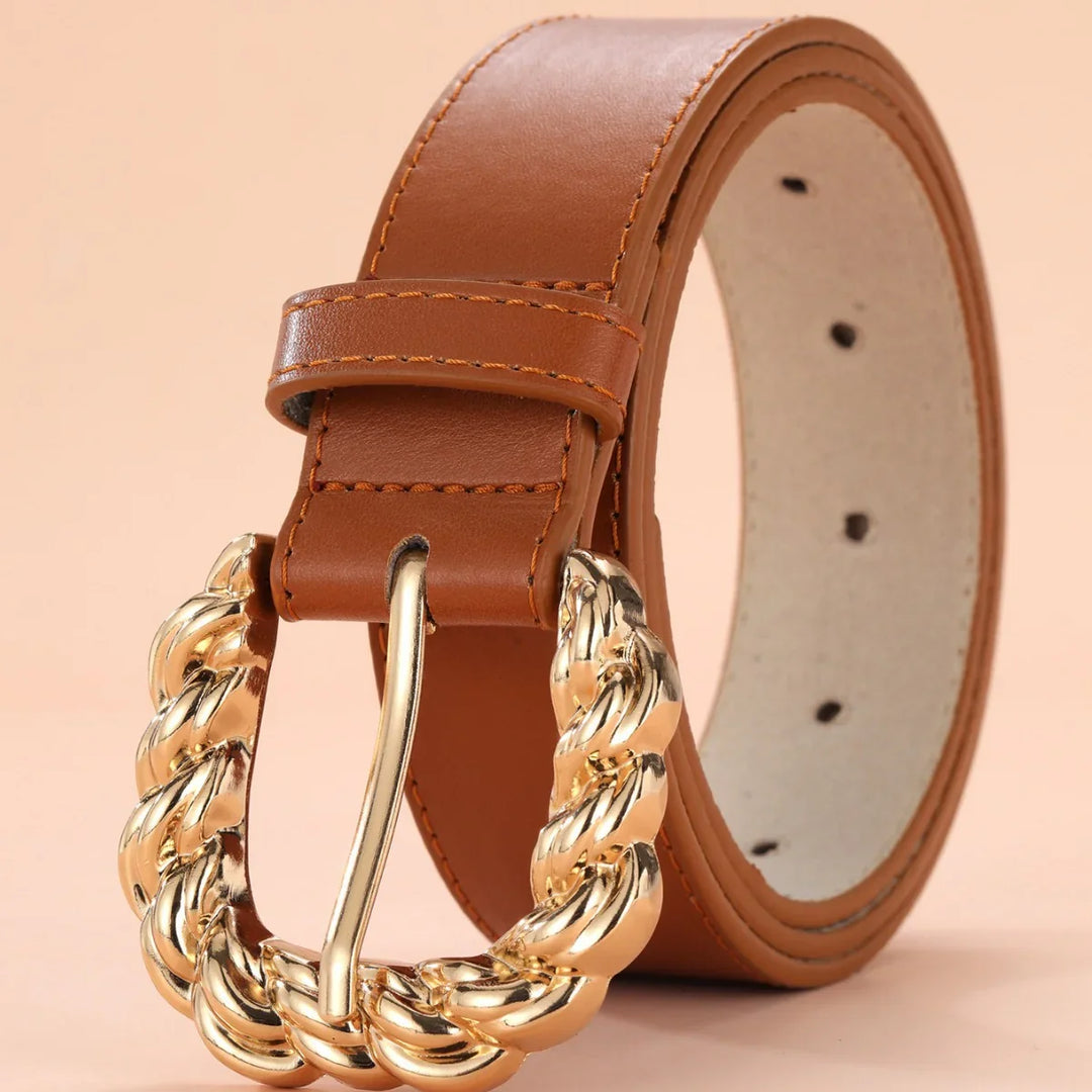 Brown leather belt with gold twisted chain buckle on beige background