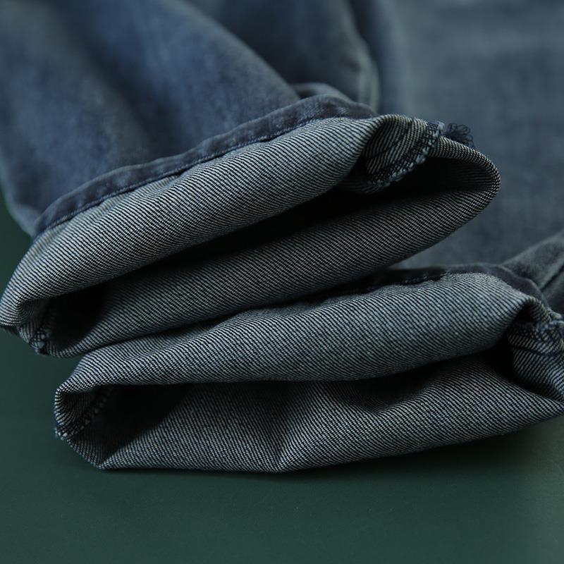 Close-up of folded dark blue denim jeans showing textured fabric and seams