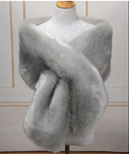 luxurious soft grey faux fur shawl draped on white lace mannequin against neutral background