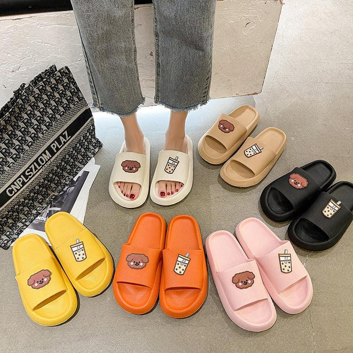 Colorful cartoon bear and bubble tea print slide sandals in white, beige, black, pink, orange, and yellow on floor