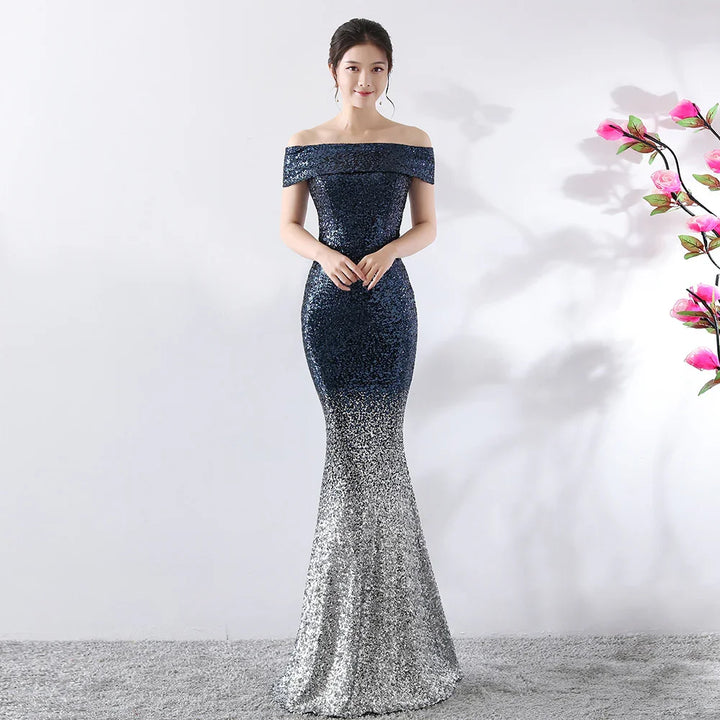 Woman wearing off-shoulder navy blue to silver sequin mermaid evening gown with floral decor