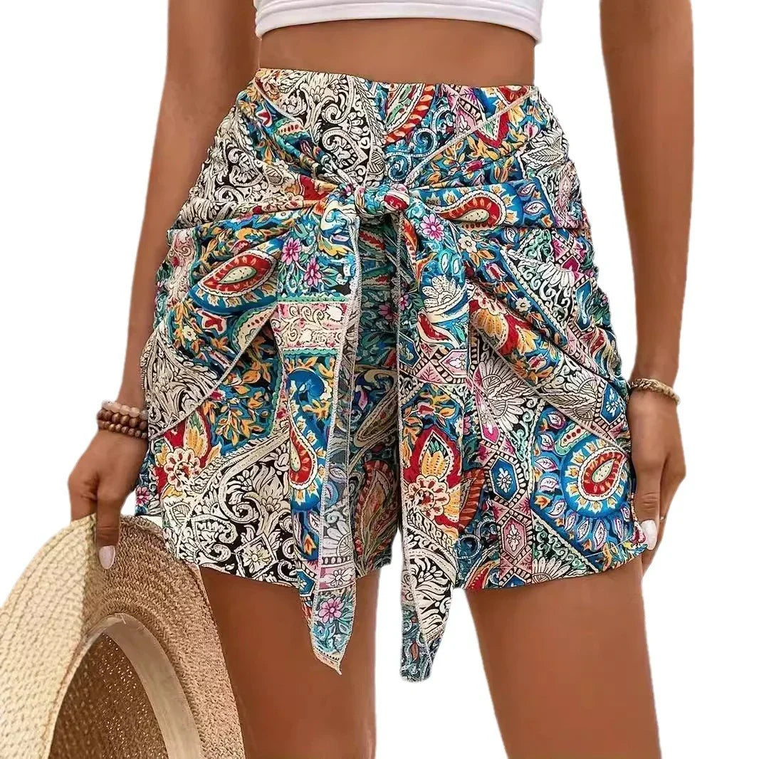 Women's colorful boho print high-waist shorts with front tie belt, styled with white crop top
