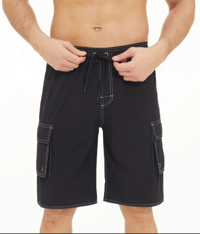 Man wearing black cargo board shorts with white stitching and drawstring waist detail